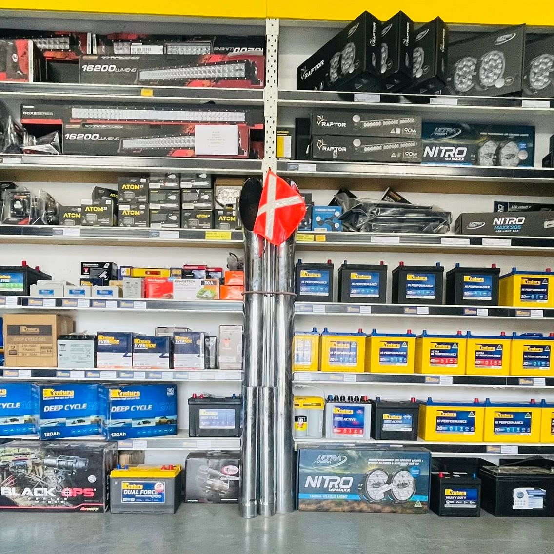 Parts shelving with batteries and chrome exhaust stacks