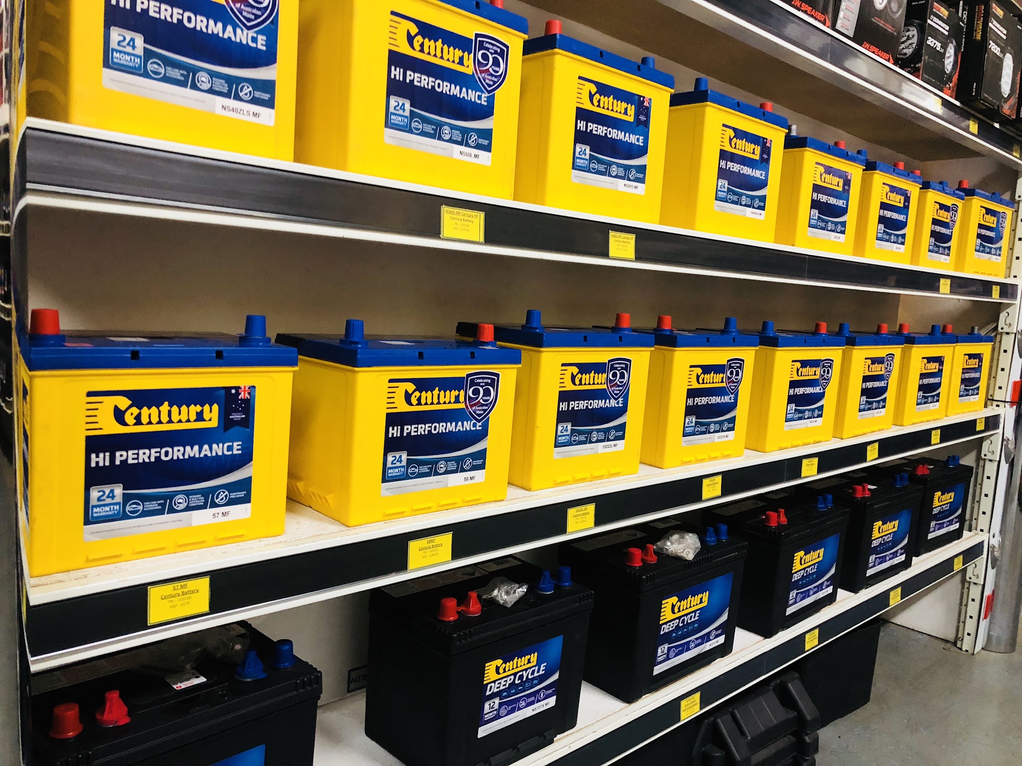 A wall of yellow Century Hi Performance batteries on the shop shelves