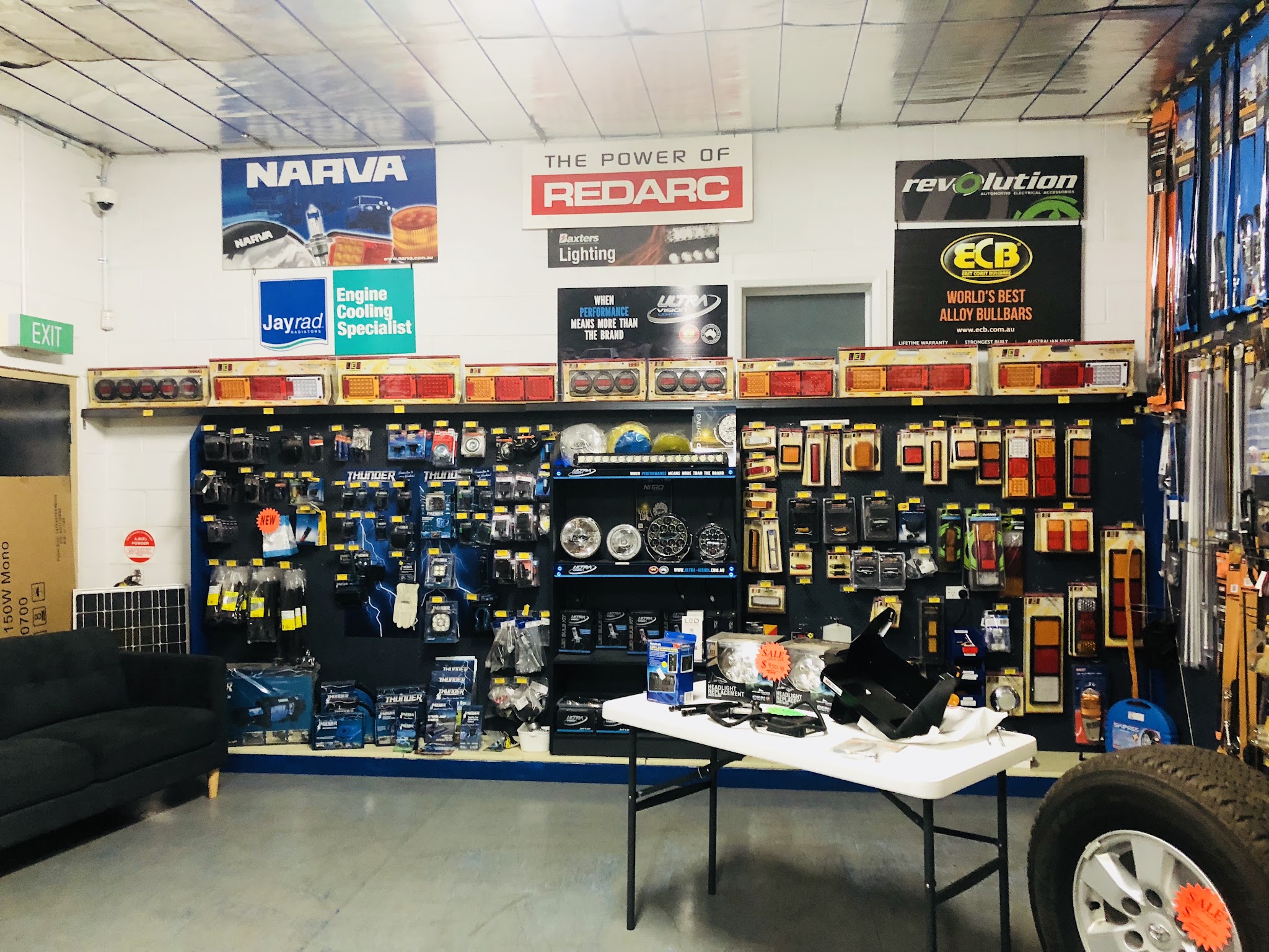 Inside the parts shop on Vyner Street, with brand boards above racks of auto electrical stock