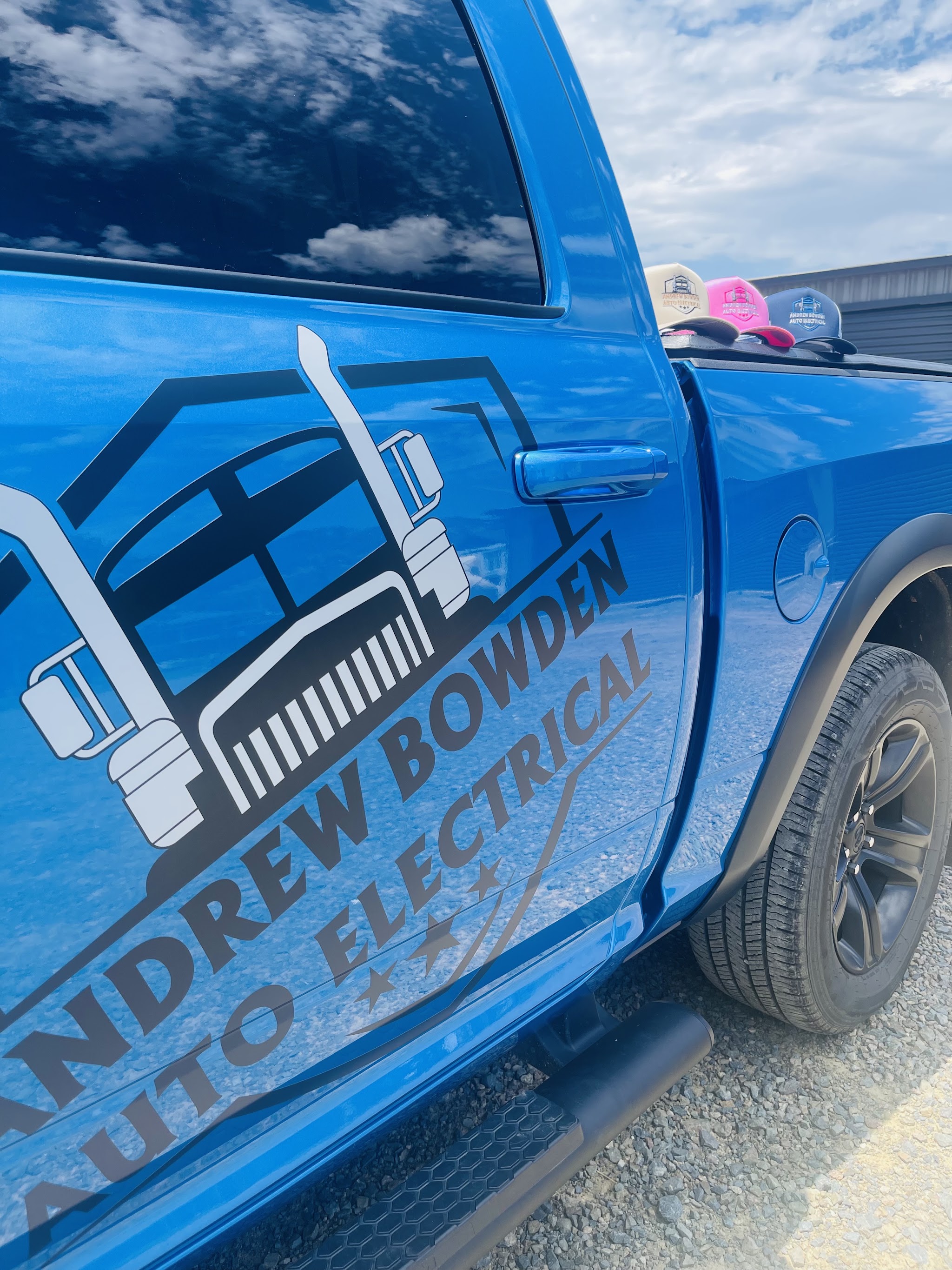 The Andrew Bowden Auto Electrical badge on the door of the blue service ute
